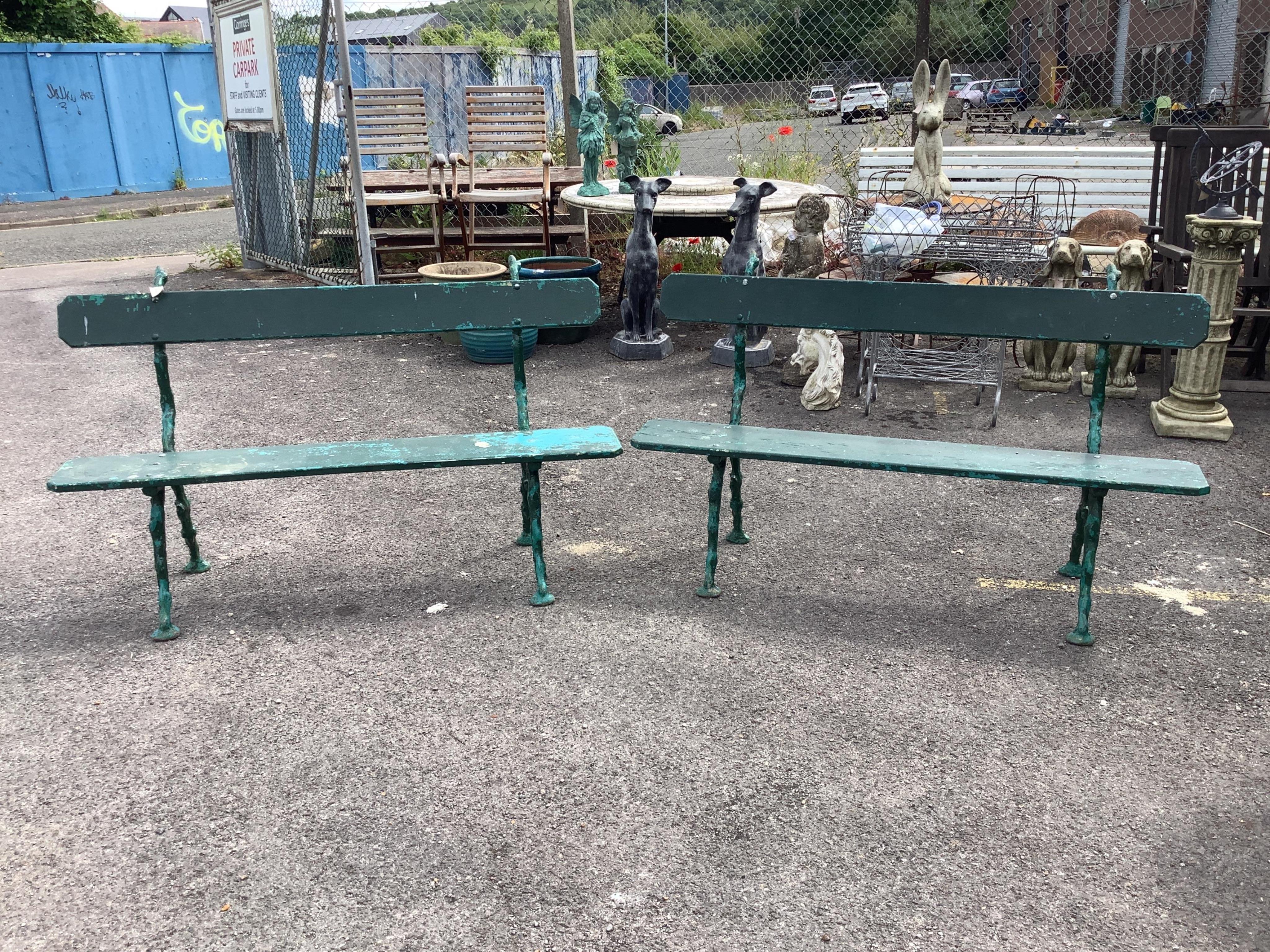 A pair of Coalbrookdale style painted cast metal garden benches, width 150cm, depth 50cm, height 91cm. Condition - fair